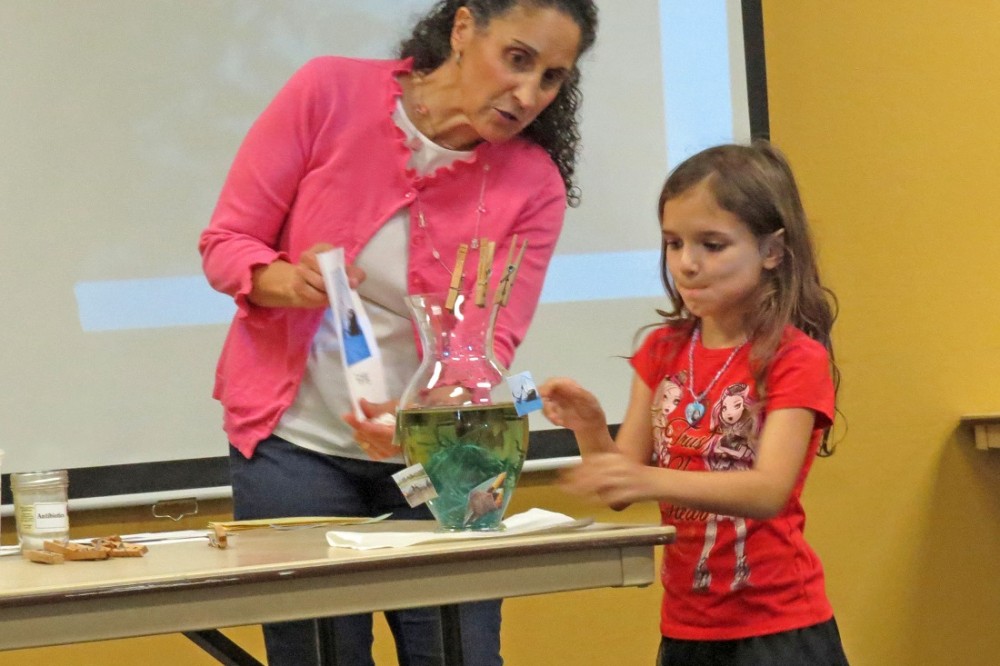 Patricia Newman doing an experiment with a young reader