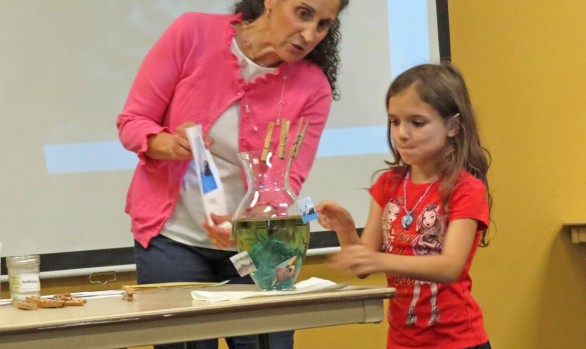 Patricia Newman doing an experiment with a young reader