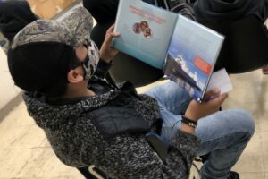 Middle school student reading PLASTIC, AHOY!