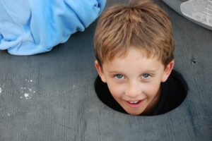 Boy-poking-head-out-of-hole